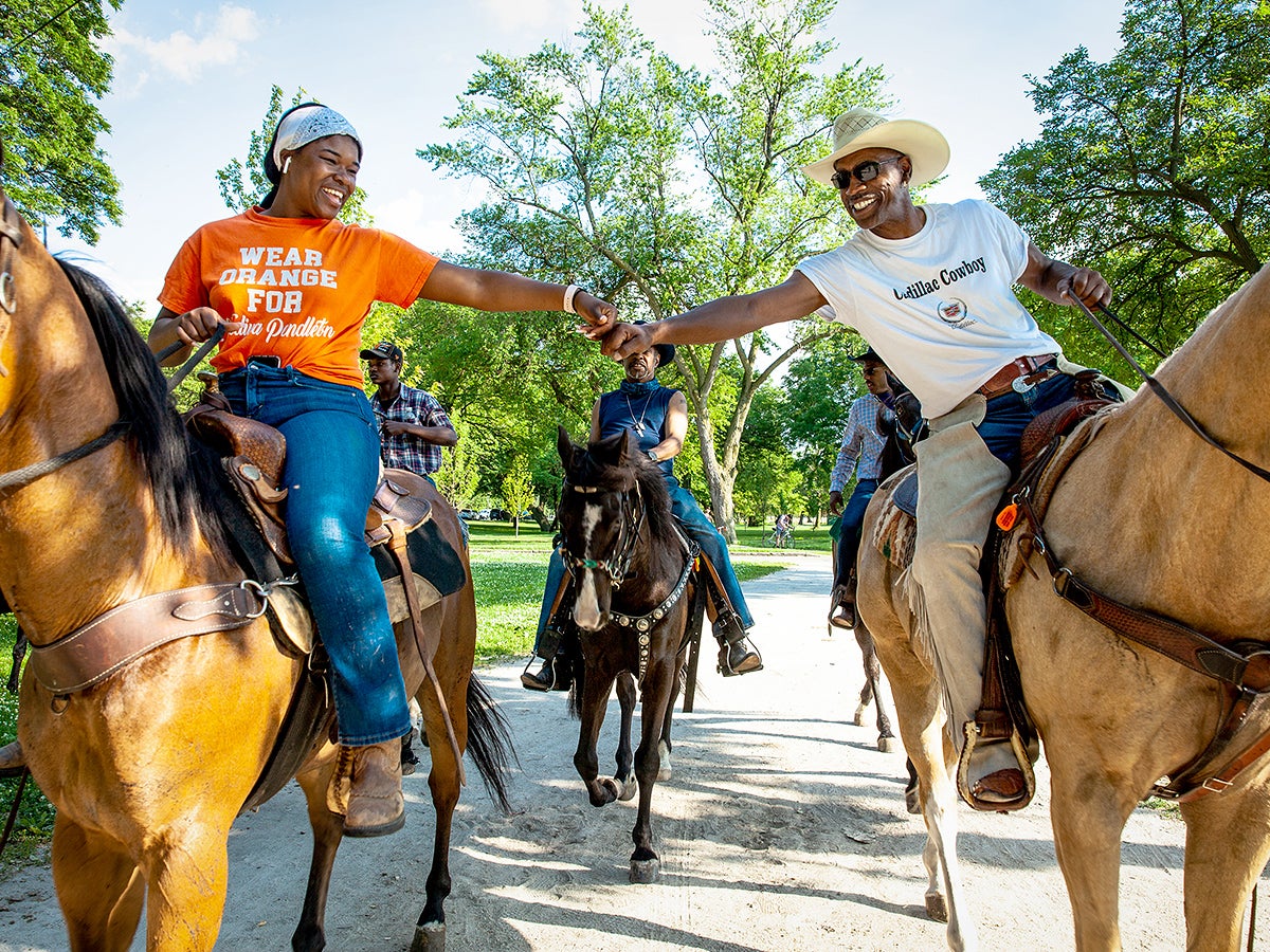 Black equestrians ride through Chicago&#039;s Washington Park for a Juneteenth celebration in June 2020.