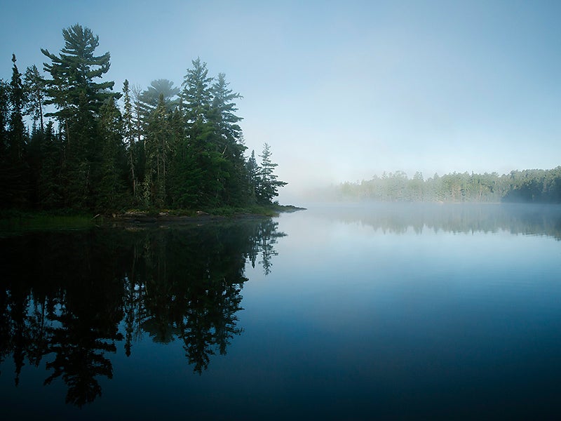 Mist on the water in early morning at the Boundary Waters Canoe Area Wilderness in Northern Minnesota.