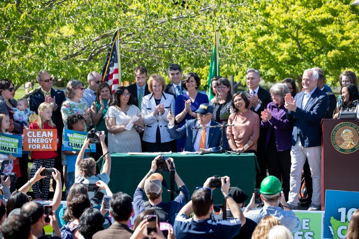 Gov. Jay Inslee signs a bill that establishes a 100% clean energy target for Washington state.