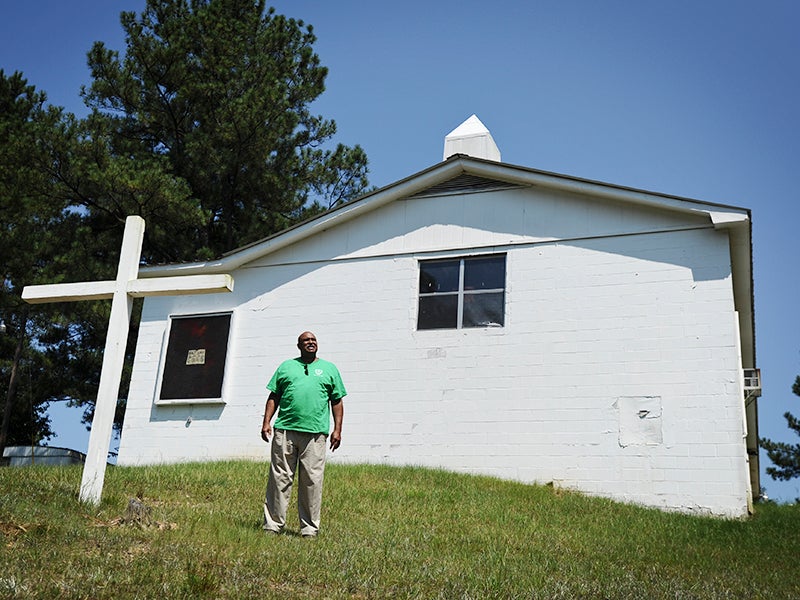 Ron Smith stands outside New Zion Church, next to Stone's Throw landfill, near Tallassee, Ala. Community members meet at this church regularly to discuss issues related to the landfill.
(Jeronimo Nisa for Earthjustice)