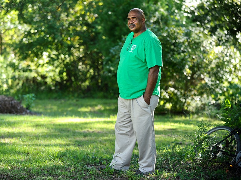 Ron Smith stands on the property that his family has owned since his great-grandfather's time. A landfill built adjacent to the property is the subject of an unanswered EPA complaint filed 13 years ago.
(Jeronimo Nisa for Earthjustice)