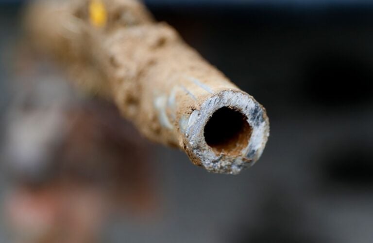 A lead pipe is shown after being replaced by a copper water supply line to a home in Flint, Mich., July 20, 2018. The Environmental Protection Agency will soon strengthen lead in drinking water regulations. (Paul Sancya / AP)