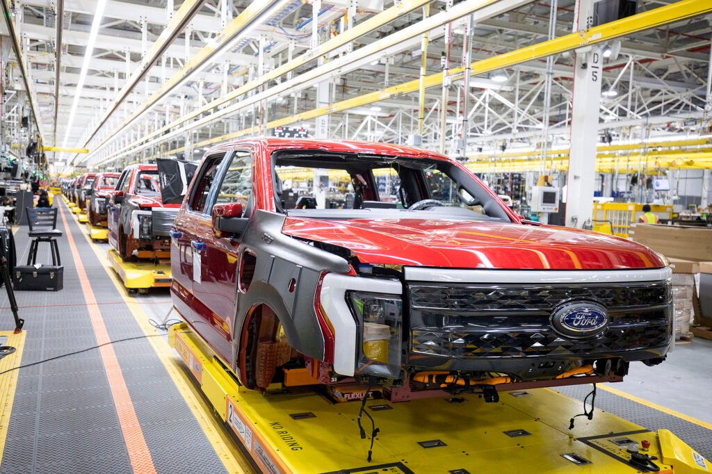 Ford F-150 Lightning pickup trucks sit on the production line at the Ford Rouge Electric Vehicle Center in Dearborn, Michigan. (Bill Pugliano / Getty Images)