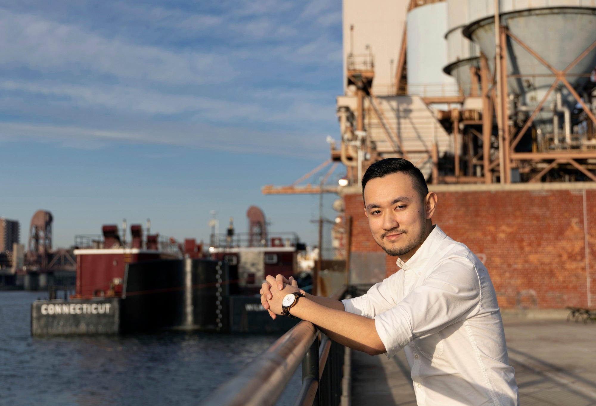 Daniel Chu, an energy planner for the NYC Environmental Justice Alliance, photographed in Queensbridge Park, next to the Ravenswood Generating Station in Queens, New York.