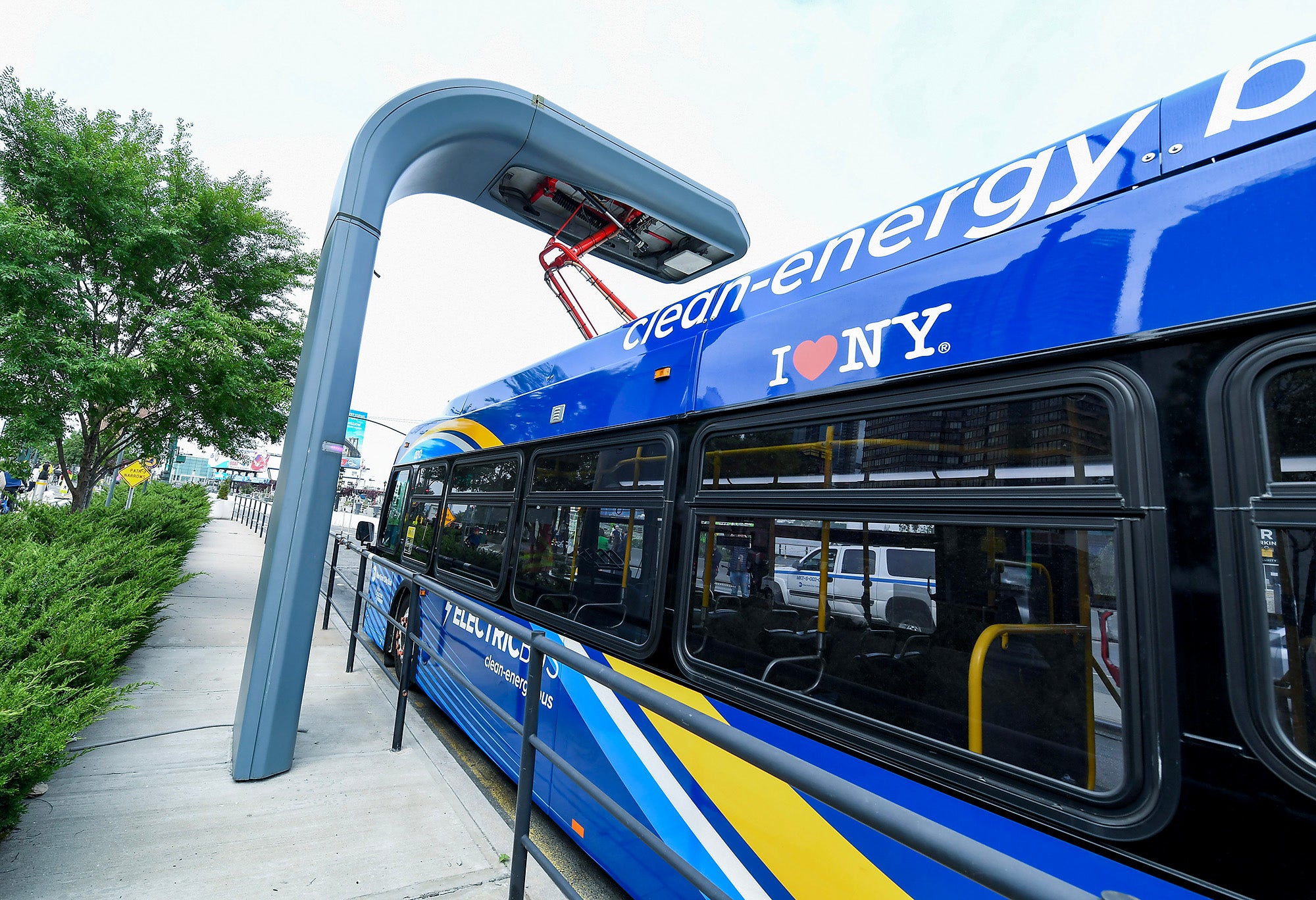 A New York City MTA electric bus at a charging station on the West Side Highway at 42 St.