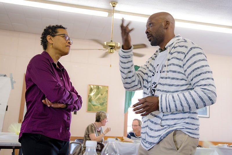 Earthjustice attorney Adrienne Bloch speaks with a community member at a RISE St. James meeting.