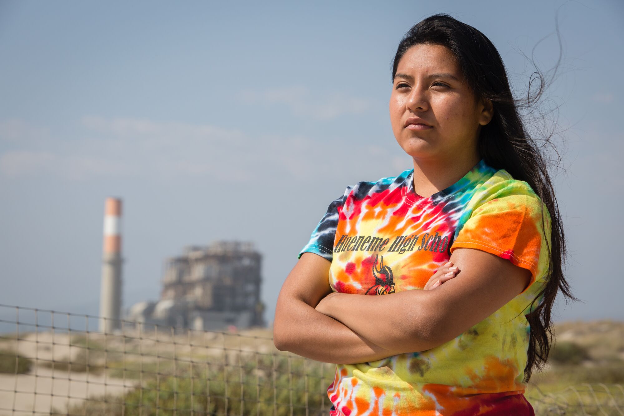 Lilian Bello in front of the Mandalay Generating Station in Oxnard, CA. The location was set to be the site of the Puente Power Station, a proposed gas power plant.