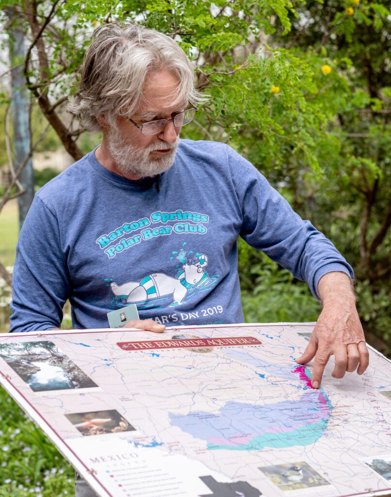 Bill Bunch is pointing to a map of the Edwards Aquifer.