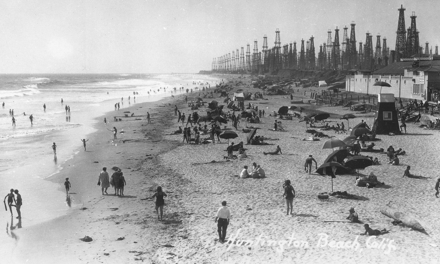 Oil derricks line Huntington Beach, California, circa 1930.