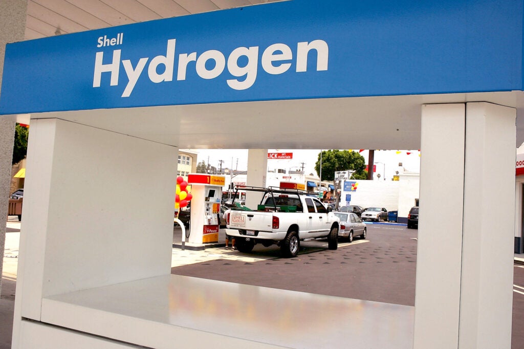 A pickup truck being filled with gasoline near a hydrogen fuel pump at the first hydrogen refueling station in Los Angeles.