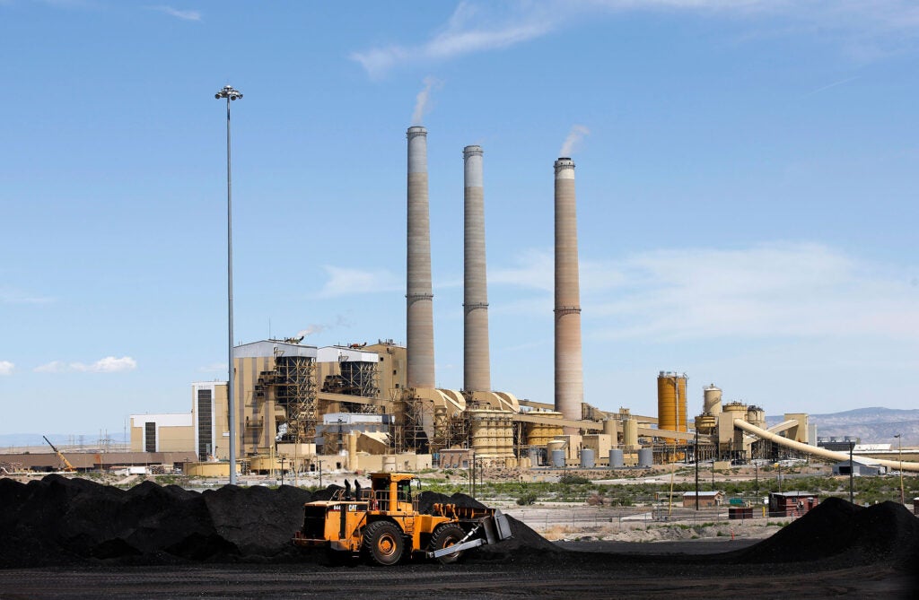 A loader moves coal piles that sit outside the Hunter Power plant operated by PacifiCorp that are waiting to be burned to produce electricity on June 3, 2016 outside Castle Dale, Utah.