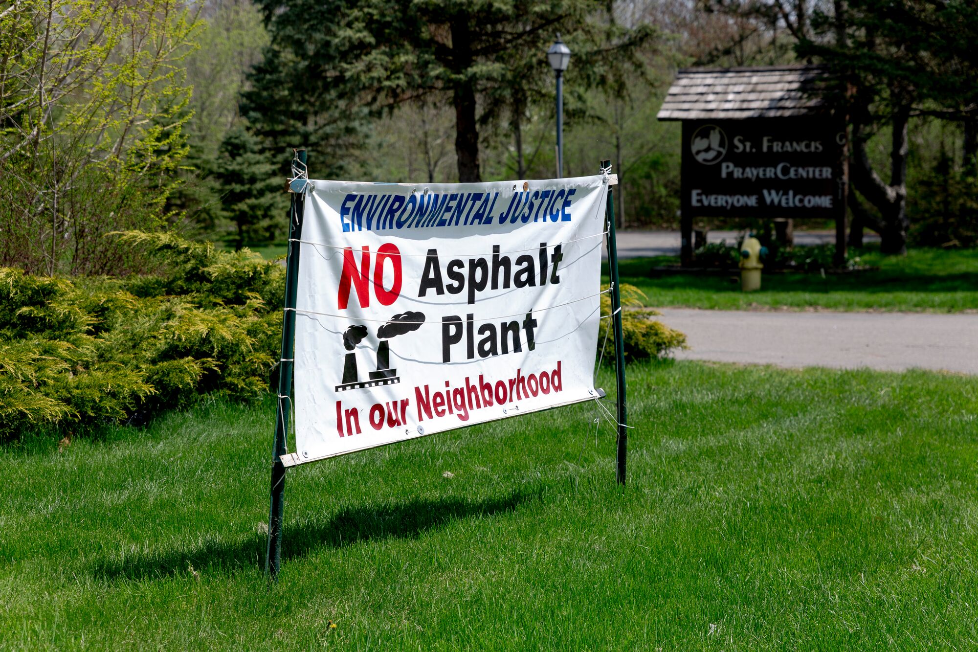 A sign protesting the asphalt plant is seen outside of St. Francis Prayer Center on May 10, 2022 in Flint, Michigan.