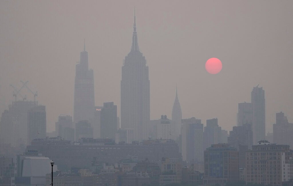 The sun rises over a hazy New York City skyline as seen from Jersey City, New Jersey, Wednesday, June 7, 2023. Intense Canadian wildfires are blanketing the northeastern U.S. in a dystopian haze, turning the air acrid, the sky yellowish gray and prompting warnings for vulnerable populations to stay inside. (Seth Wenig / AP)