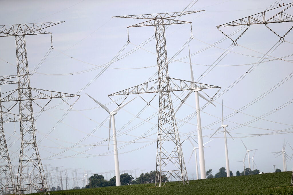 Power lines and power generating windmills rise above the rural landscape near Dwight, Illinois. (Scott Olson / Getty Images)