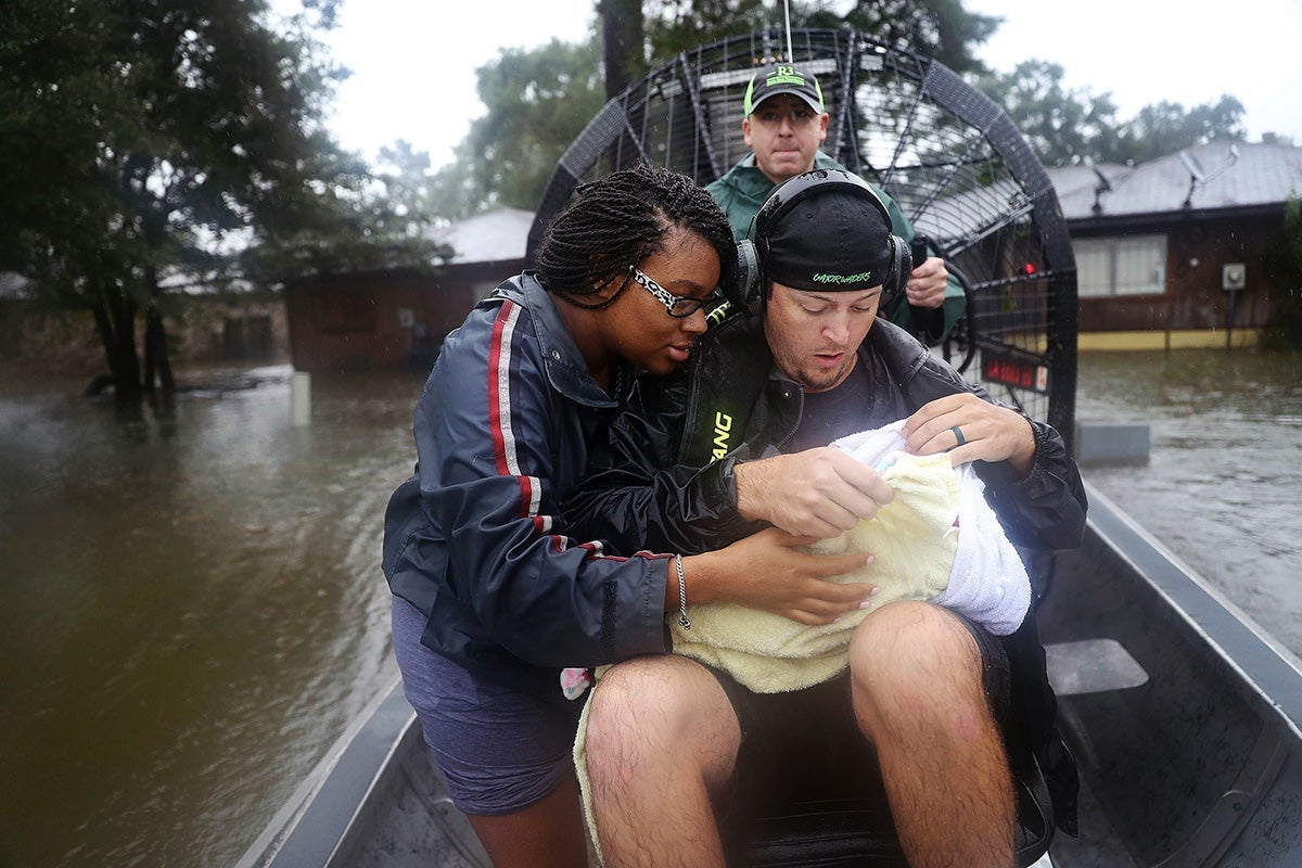 Una madre y su bebé de 3 semanas son transportados desde su casa en medio de las inundaciones del huracán Harvey en 2017. (Joe Raedle / Getty Images)