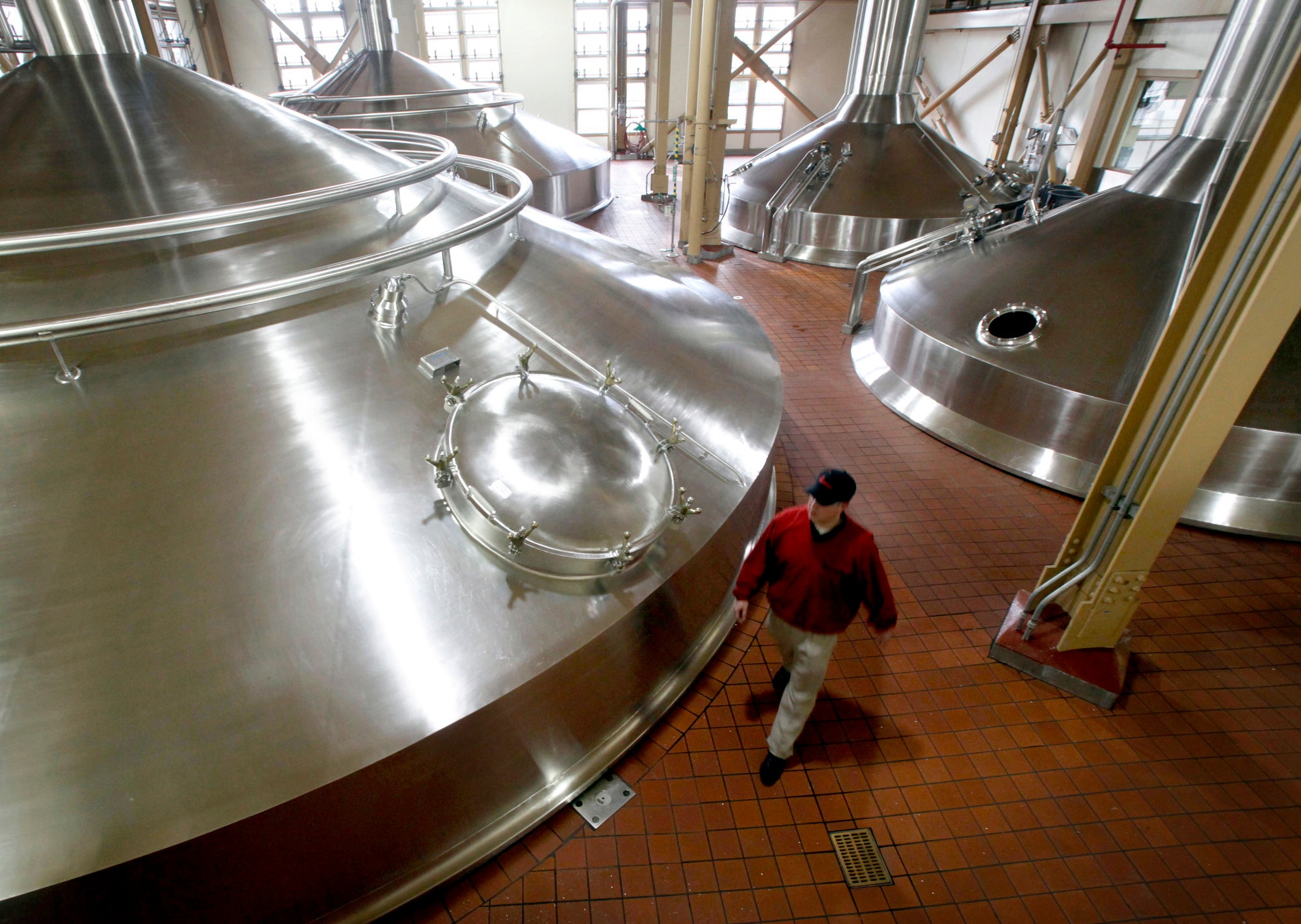 overhead view of very large stainless steel tanks sticking out of the floor.