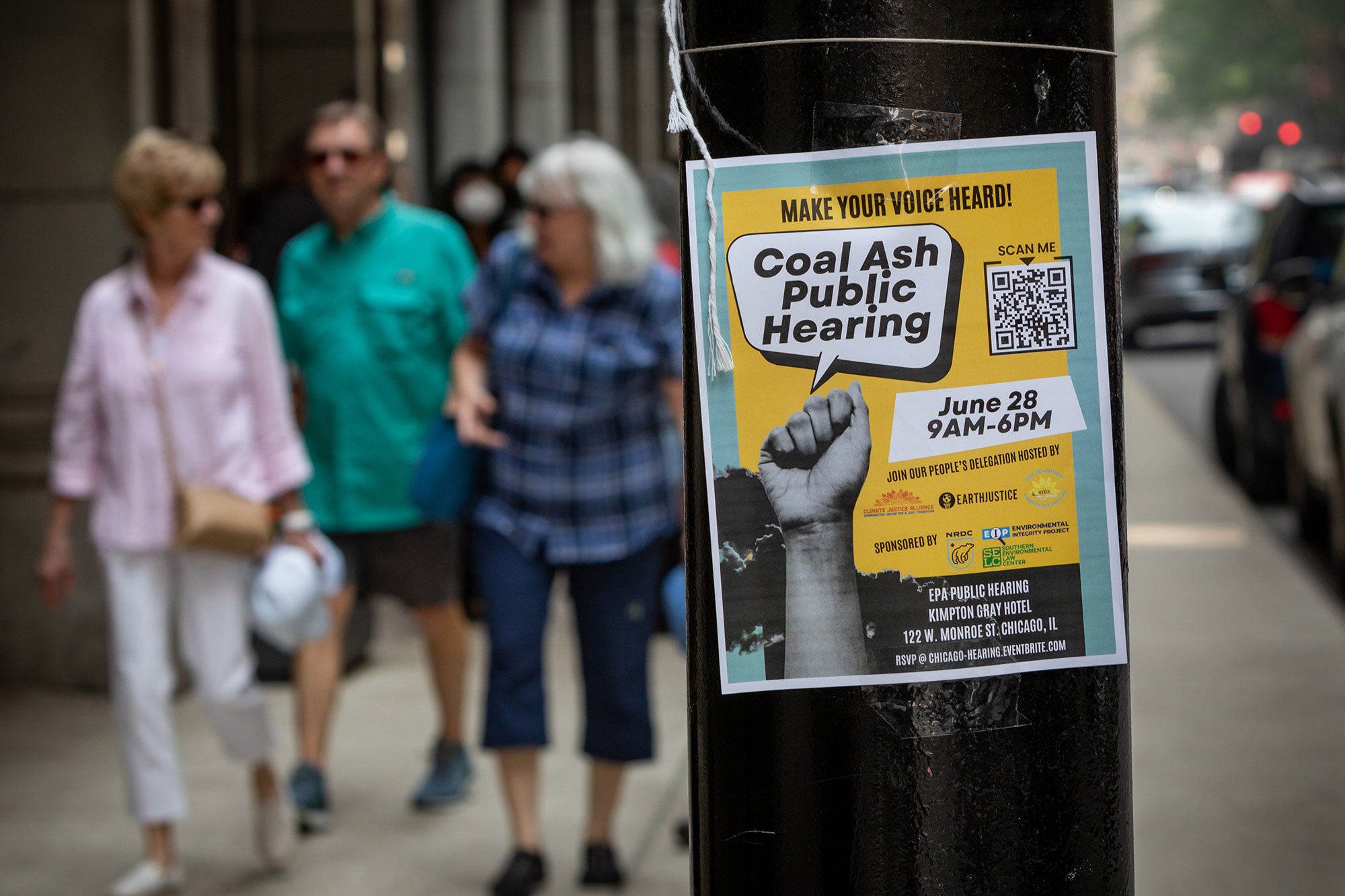 A sign notifying the public of the EPA's public hearing is taped to a utility pole on the streets of Chicago.