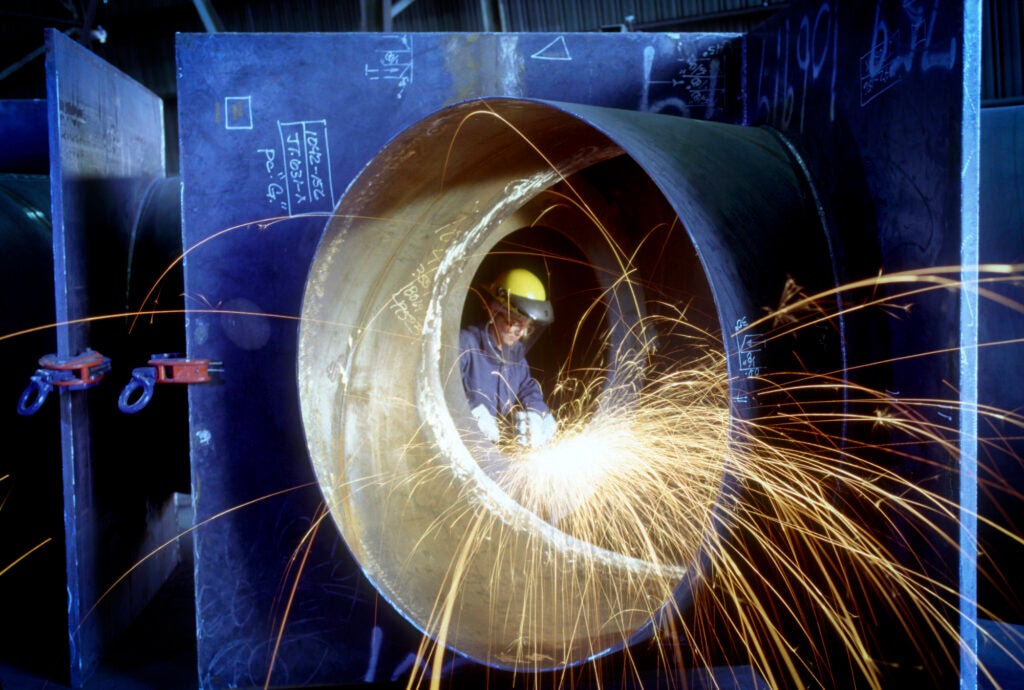A welder works on a steel pipe in Southern California. (Kevin Burke / Getty Images)