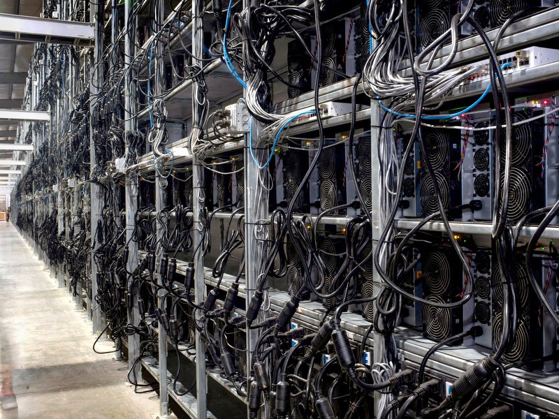 Bitcoin mining machines in a warehouse at the Whinstone US Bitcoin mining facility in Rockdale, Texas, the largest in North America. Operations like this one have been boosted by China’s intensified crypto crackdown that has pushed the industry west. (Mark Felix / AFP via Getty Images)