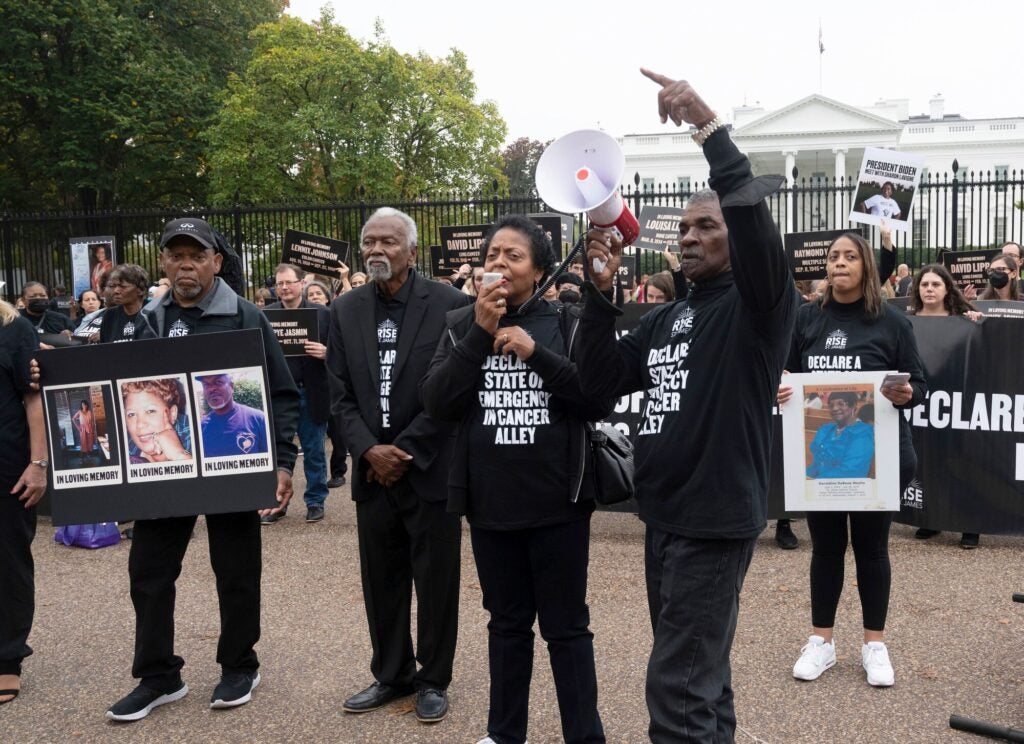 John Beard, Robert Taylor, Sharon Lavigne and Harry Joseph, left to right, speak to fellow activists from "Cancer Alley" to call on President Biden to declare a state of emergency in St. James Parrish, La., during a protest outside the White House on Oct. 25, 2022. The procession of activists carried photographs of fellow community members who died because of the toxic impact of fossil fuels. (Kevin Wolf / AP Images for Fossil Free Media)