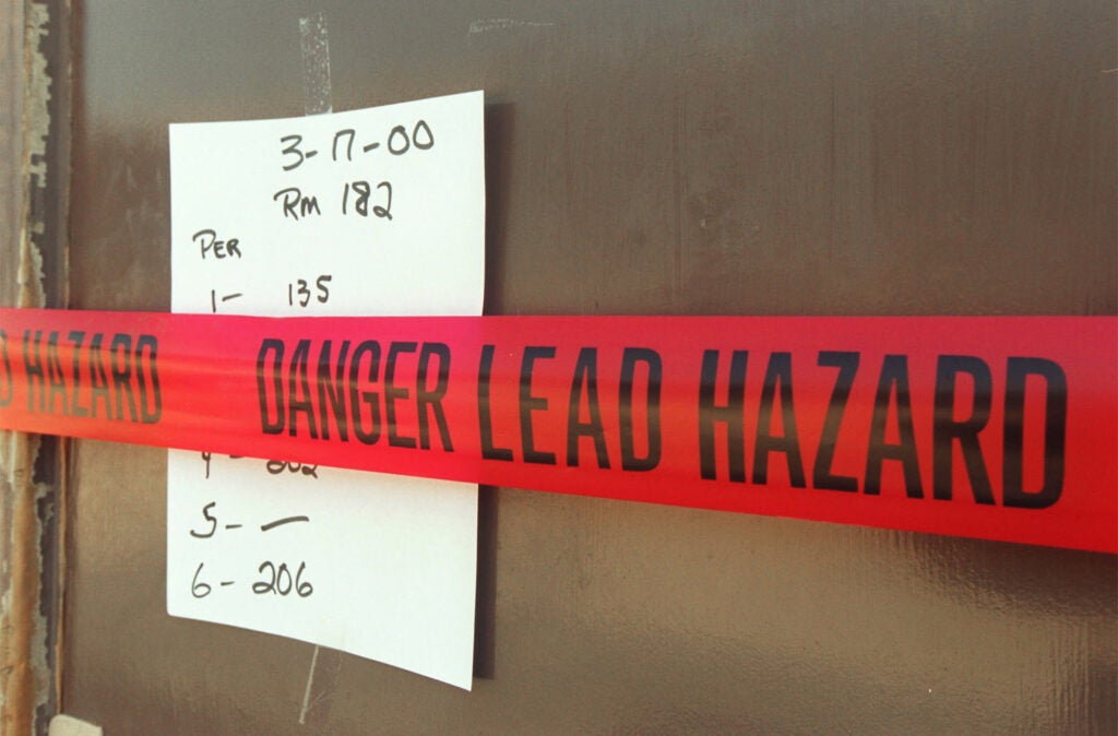 A bungalow classroom door at Walter Reed Middle School in North Hollywood has a red tape sign indicating a presence of lead in the paint. As a result, this room and others were sealed off until they can be fixed.  (Boris Yaro / Los Angeles Times via Getty Images)