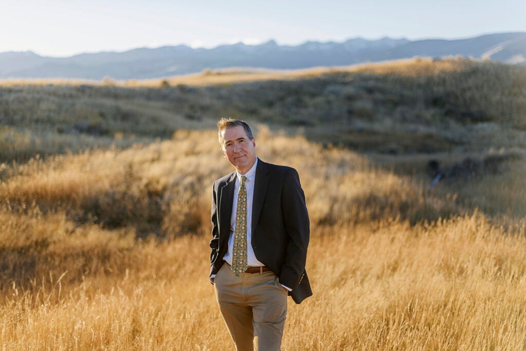 Tim Preso, in a suit photographed in a golden field.