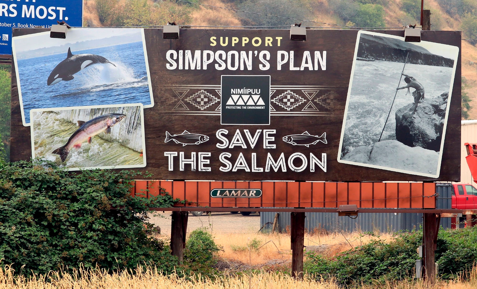 A bilboard saying save the salmon and photos of the Snake River.