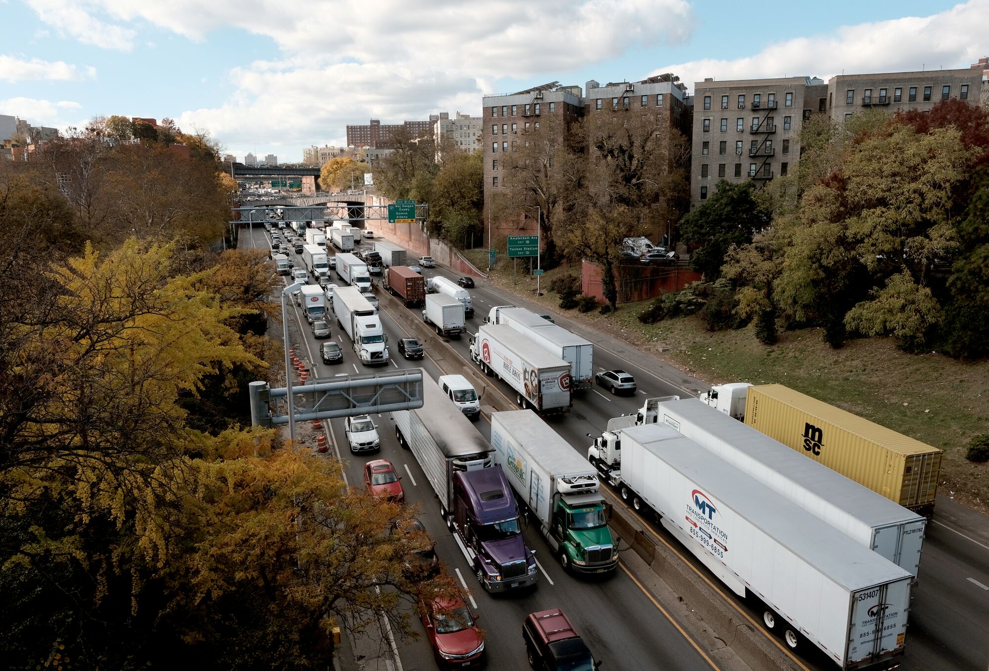 Aerial view of a freeway crowded with trucks and other vehicle traffic in New York.