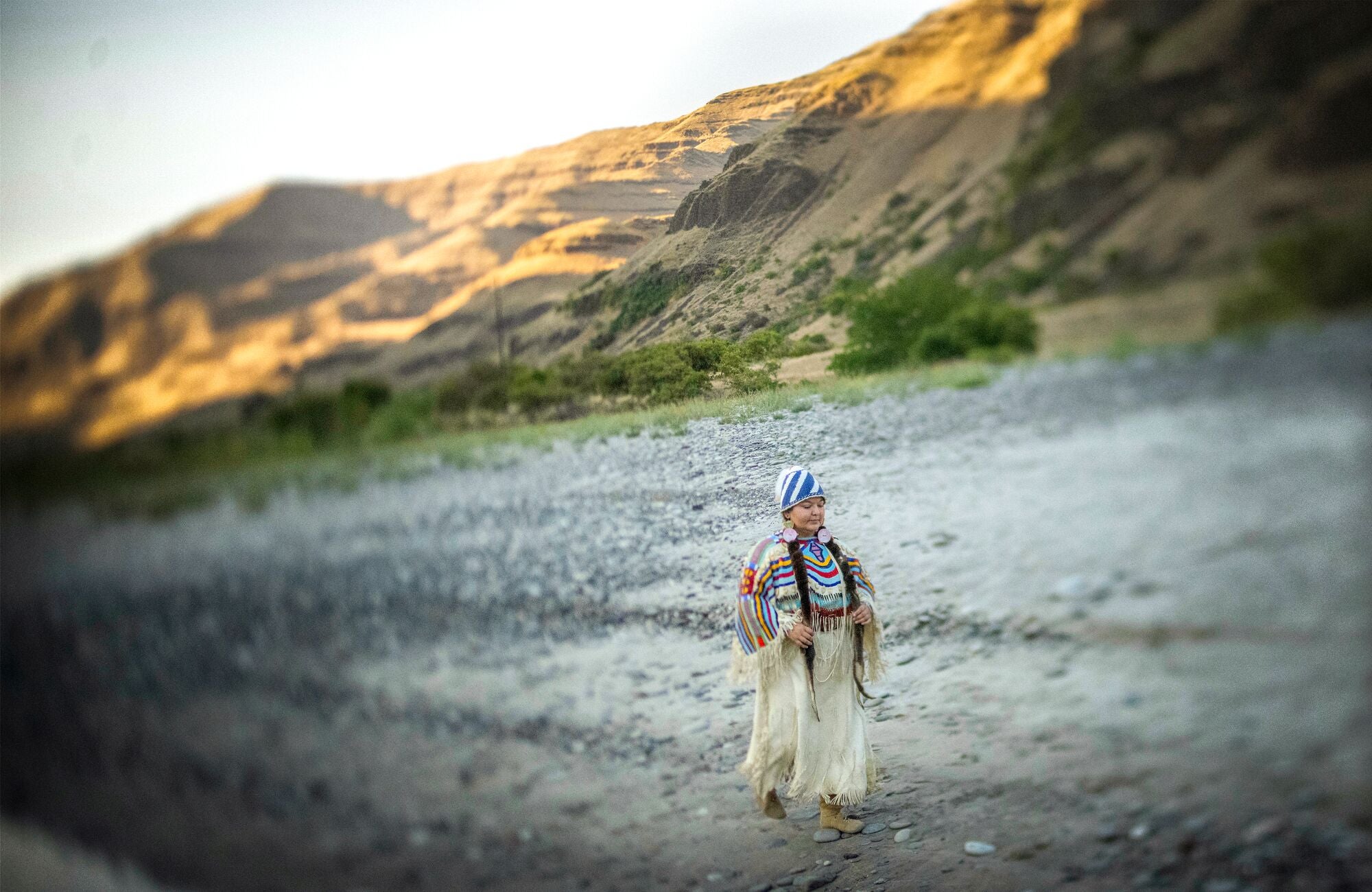 Ciarra Greene, member of the Nez Perce Tribe, walks along a section of the Snake River near Asotin, Wash.