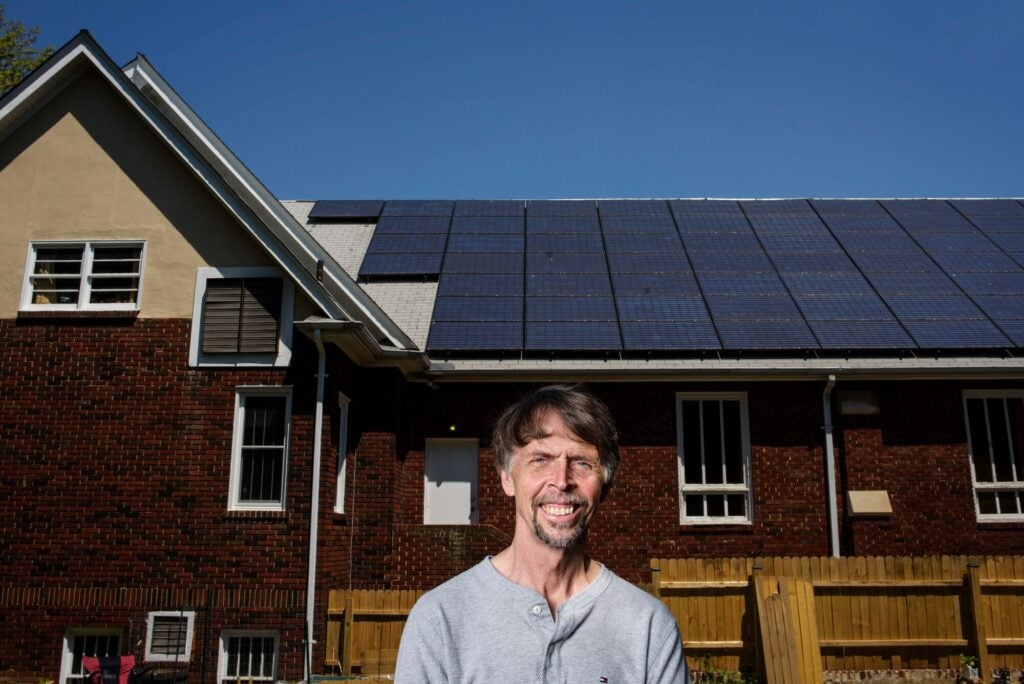 David Brosch, President of the University Park Community Solar, LLC, stands in front of a 22 kilowatt solar electric array atop the roof of the University Park Church of the Brethren in University Park, Maryland Monday May 4th, 2015. The solar panels on top of the church produces an estimated 25% more energy than the church needs per year.
