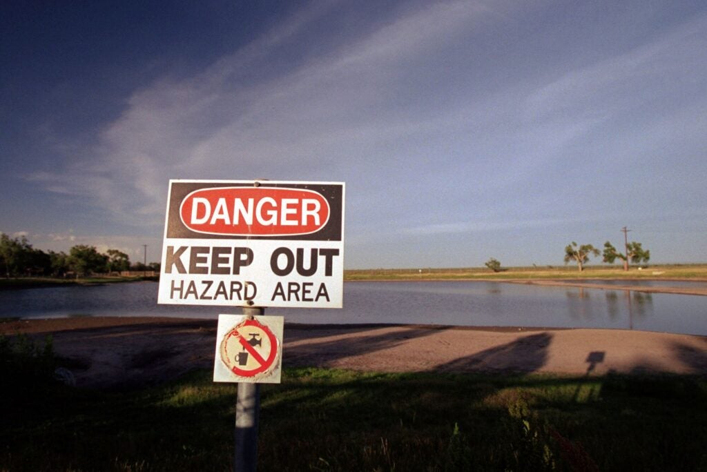 A warning sign posted near a pond contaminated with trichloroethylene and other hazardous chemicals at the former Reese Air Force Base near Lubbock, Texas. (Smiley N. Pool / Houston Chronicle via Getty Images)