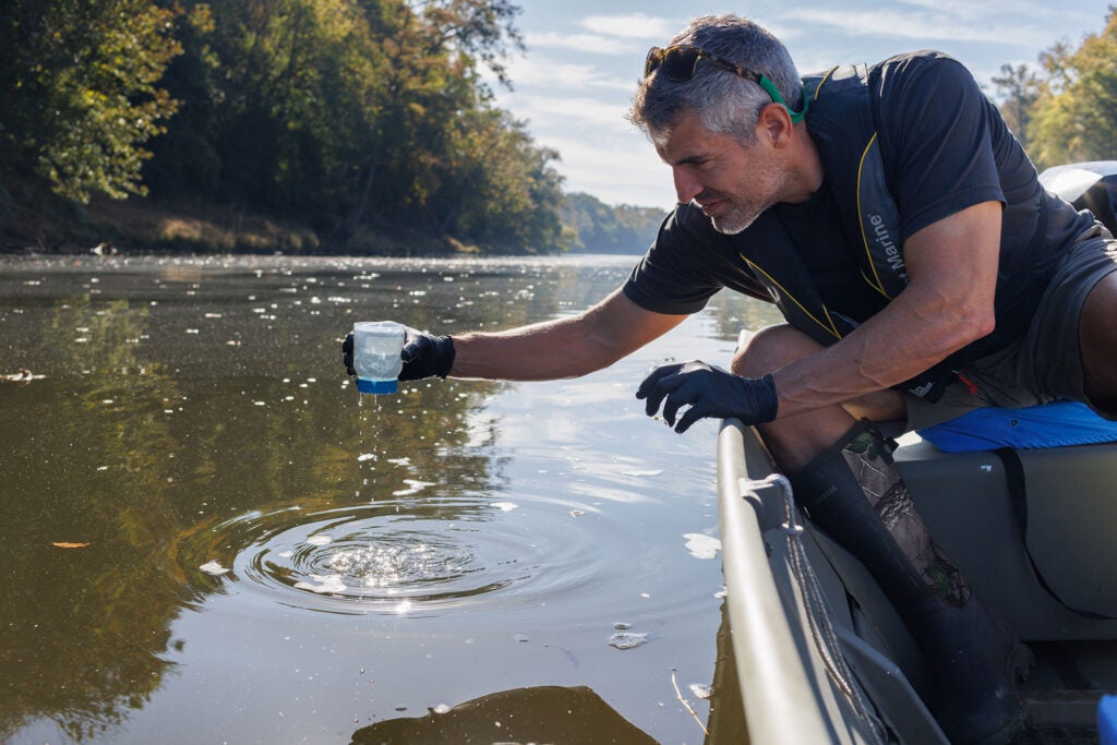 Cape Fear Riverkeeper Kemp Burdette collects water samples in the Cape Fear River near the Smithfield slaughter house in Tar Heel, N.C. (Justin Cook for Earthjustice)