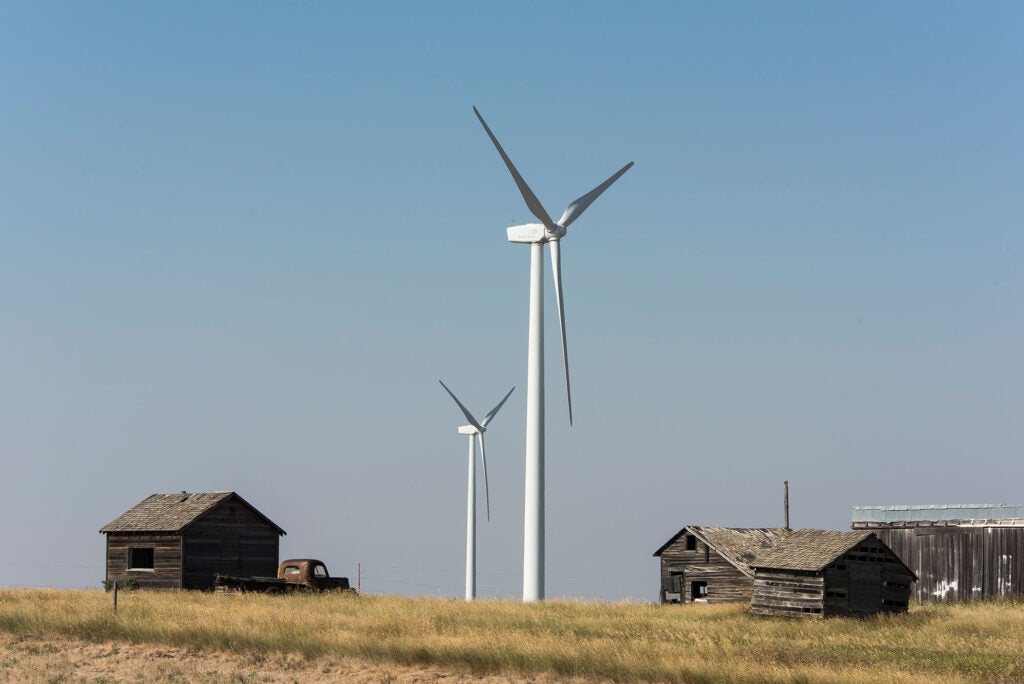 An old homestead in front of wind turbines on private working ranch land near Kevin, Montana. (William Campbell / Corbis via Getty Images)