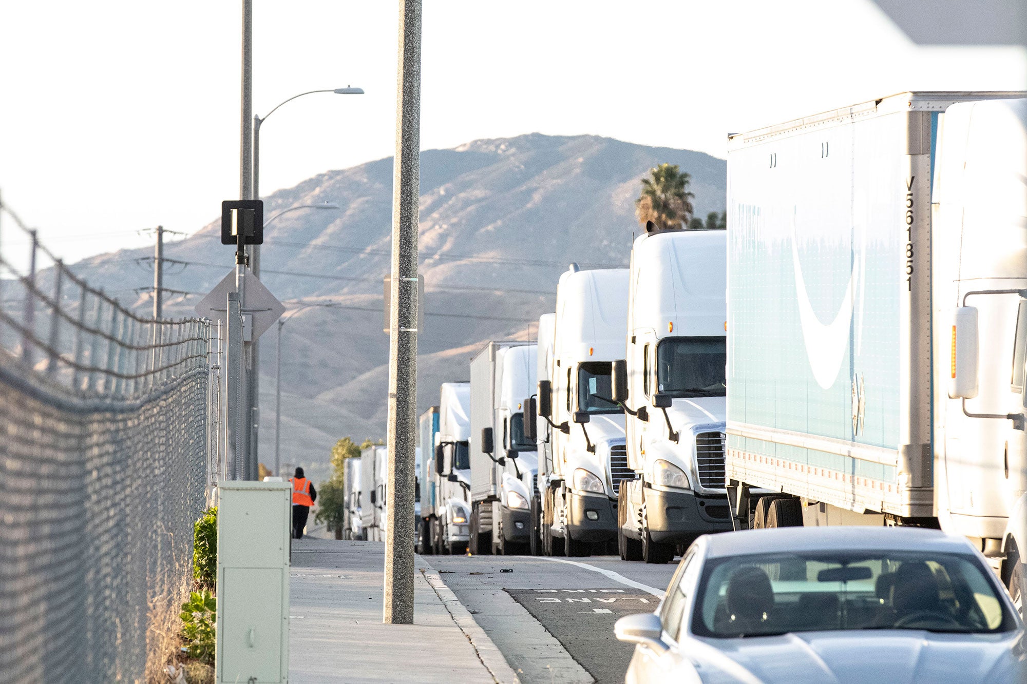Freight trucks line up outside of a warehouse on Cyber Monday in 2019.