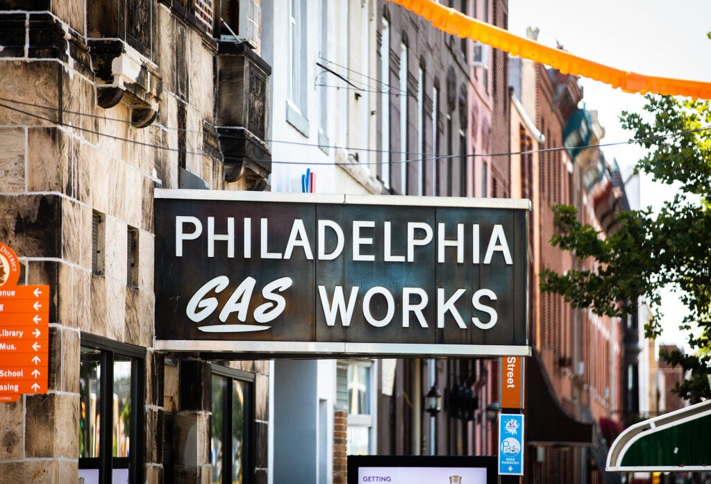 An older looking sign on a building on a city street that reads "Philadelphia Gas Works"