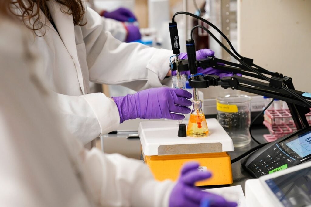 A water researcher tests a sample of water for PFAS at the U.S. Environmental Protection Agency Center For Environmental Solutions and Emergency Response in Cincinnati. (Joshua A. Bickel / AP)