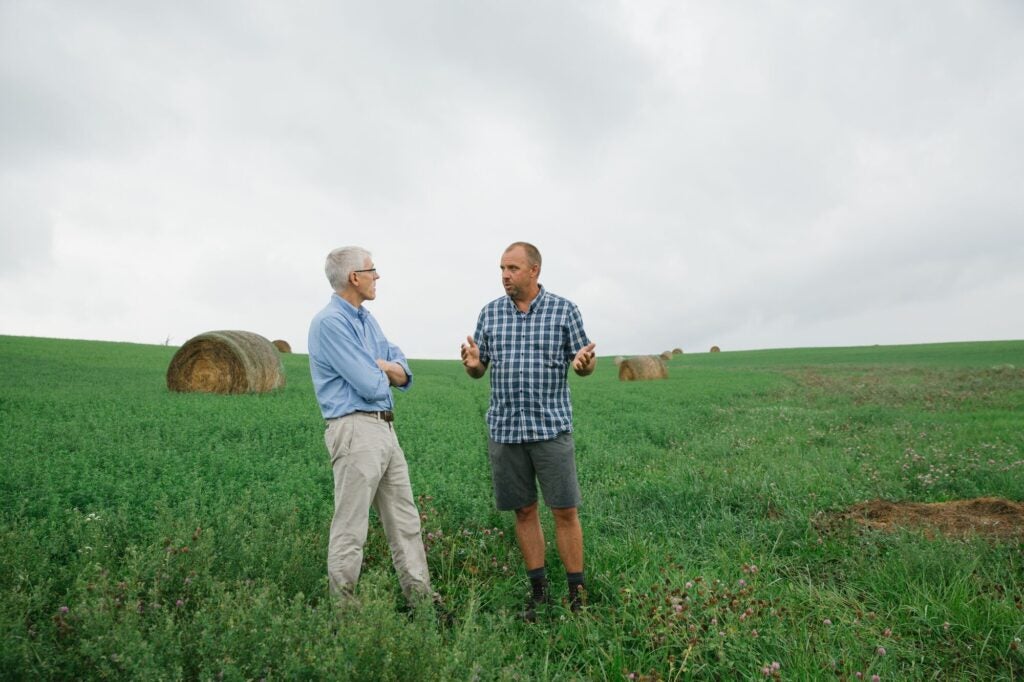 Peter Lehner (left), managing attorney of Earthjustice’s Sustainable Food & Farming Program, discusses restorative, climate-friendly farming practices on Seth Watkins’ farm in Iowa. (Brad Zweerink / Earthjustice)