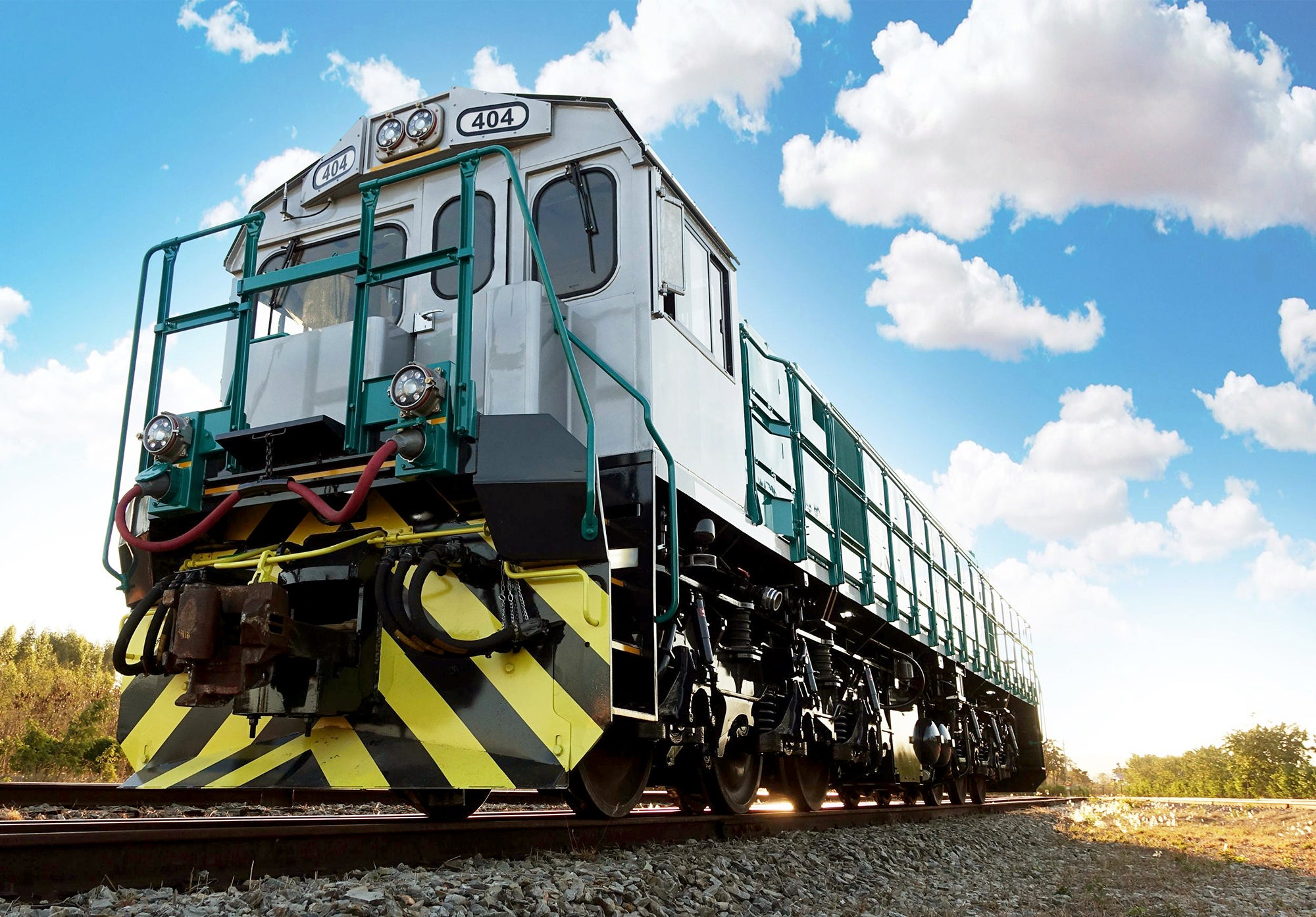 A low angle photo of a train engine without cars attached.