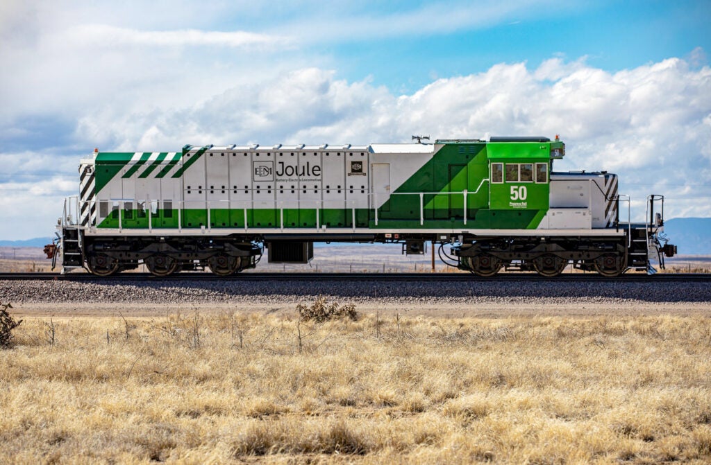 A low angle photo of a train engine without cars attached.