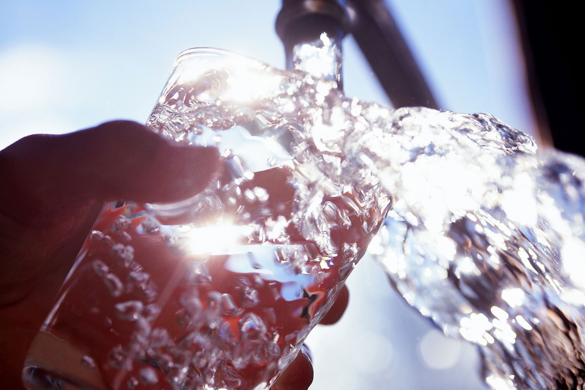 Filling glass with water.