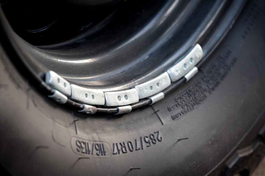 Lead weights on the rim of a car wheel, used for balance. (Ratchat / Getty Images)