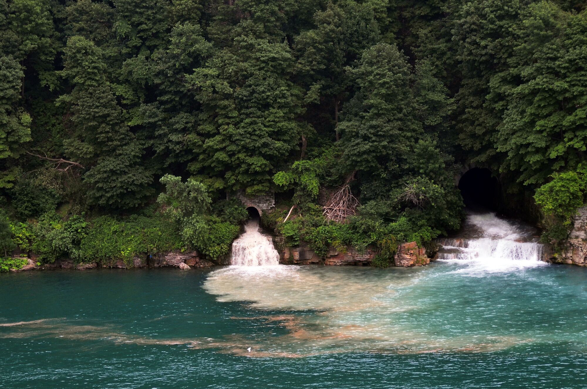 Treated wastewater effluent flows from a pipe into the Niagara River. (Brian Kennedy / Getty Images)