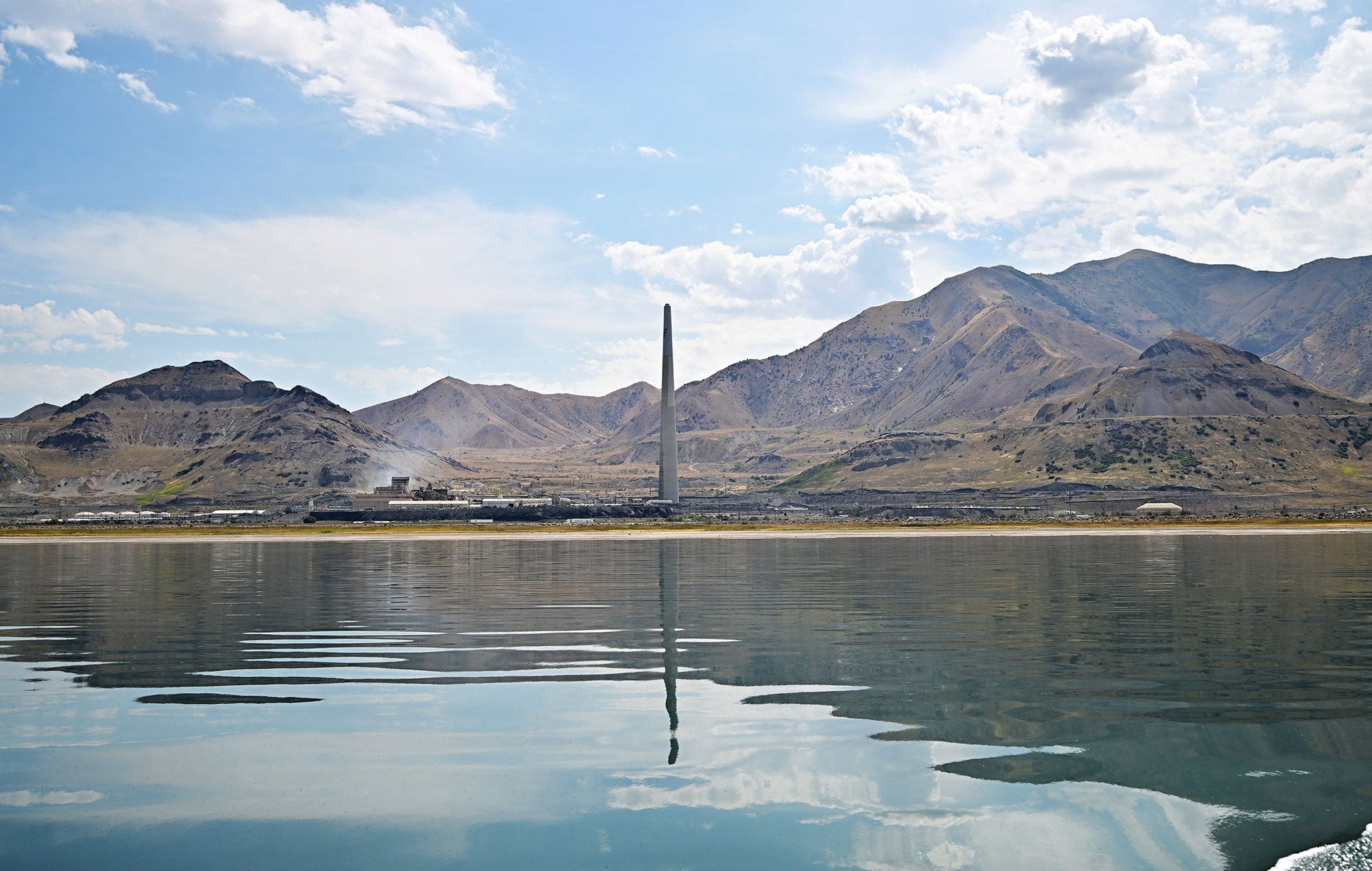 The Garfield Smelter Stack, the fourth largest smokestack chimney in the world from the Kennecott copper smelter is reflected on the water of the Great Salt Lake in Salt Lake City, Utah.