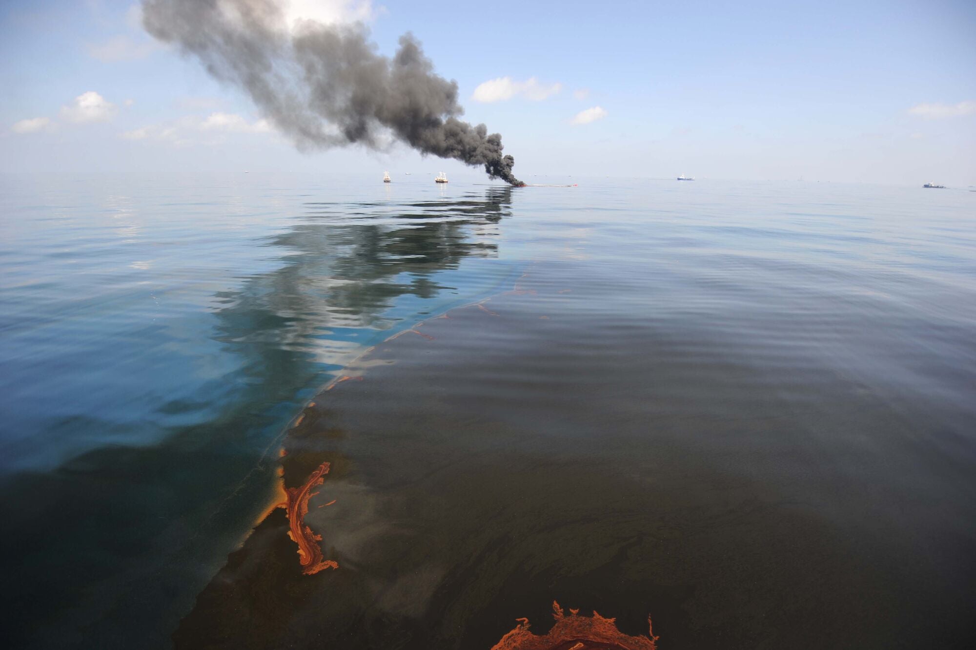 Dark clouds of smoke and fire emerge as oil burns during a controlled fire in the Gulf of Mexico.