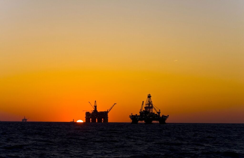 Oil platform silhouettes in the Gulf of Mexico.