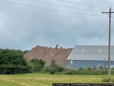 A mountain of coal ash looms over a building at the Scrubgrass Power Plant, in Kennerdell, Venango County.