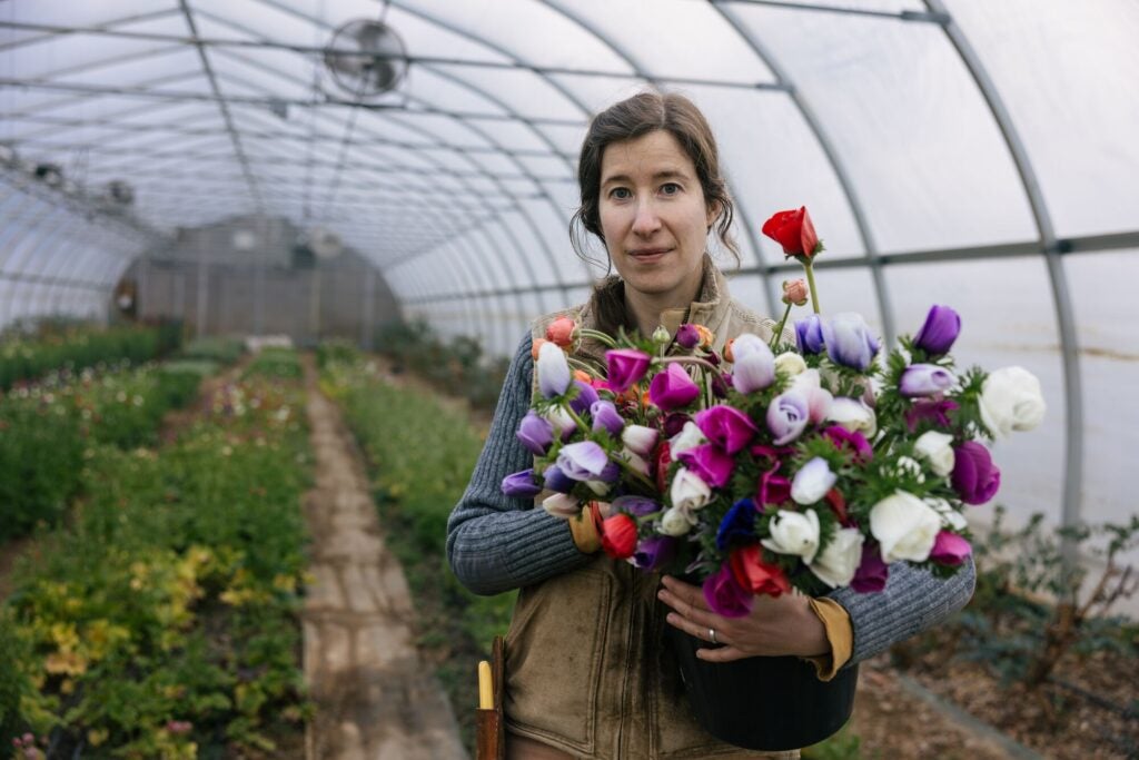 Laura Beth Resnick, owner of Butterbee Farm, holds a bundle of flowers harvested from her farm.