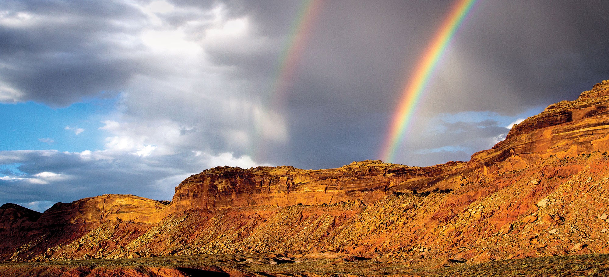 bears-ears-rainbow_2000x909 A cloudy sky with double rainbows over a monocline.