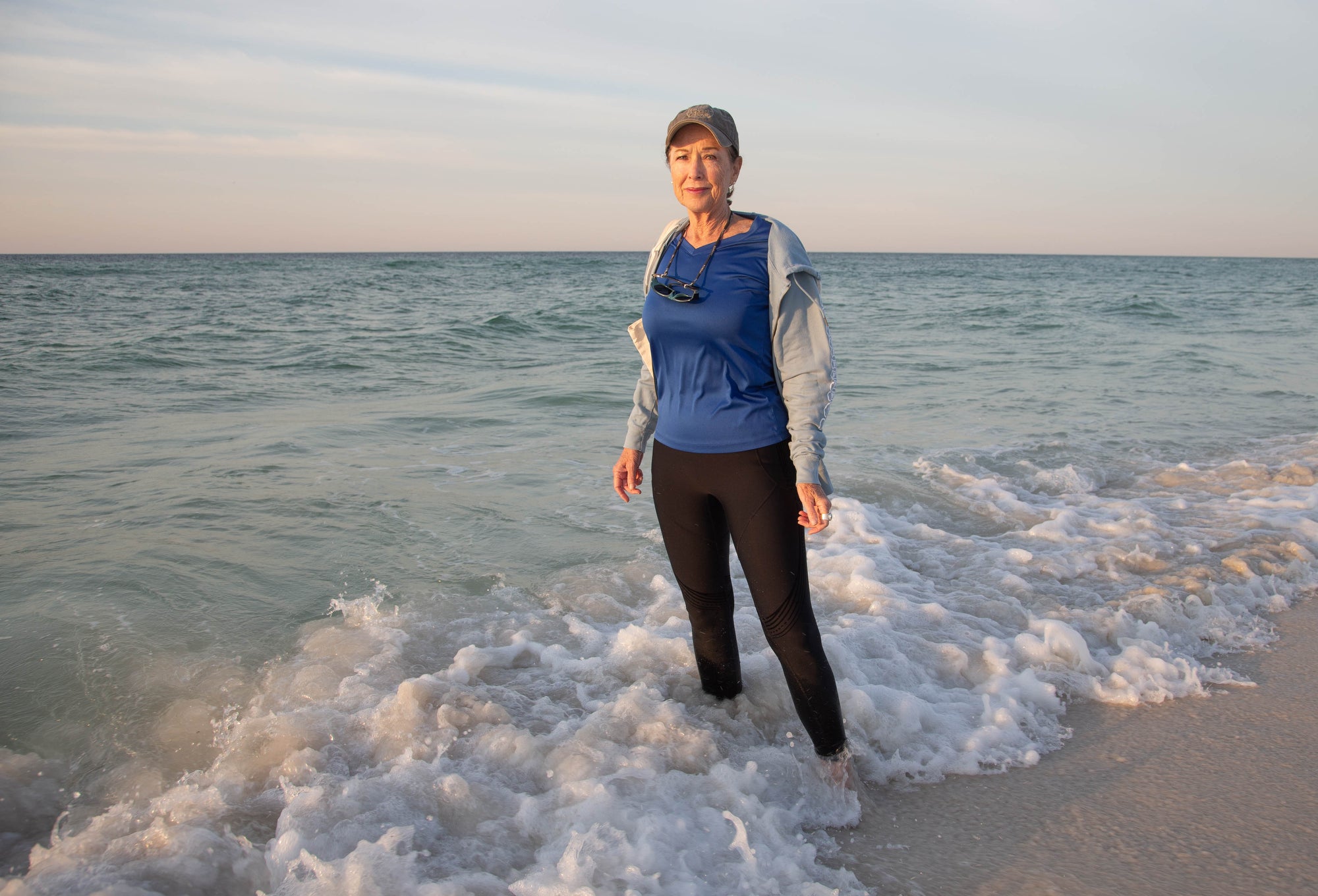 JJ Waters stands in the surf along the shore near her home in Pensacola Beach, Florida. (Gregg Pachkowski for Earthjustice)