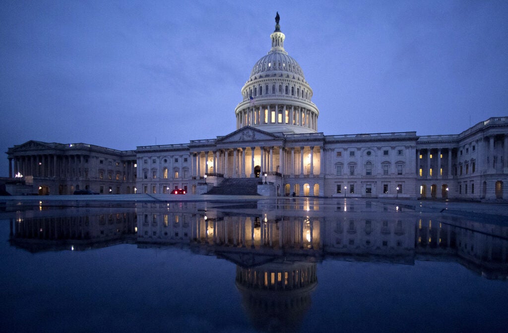 The U.S. Capitol is reflected in a fountain in Washington, D.C.  (Andrew Harrer / Bloomberg Creative via Getty)
